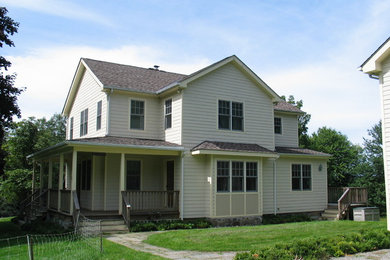 Photo of a medium sized and gey country two floor house exterior in New York with concrete fibreboard cladding and a pitched roof.