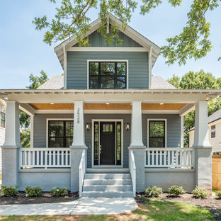 Imagen de fachada de casa azul, de estilo americano, grande, de dos plantas, con revestimiento de madera, tejado a dos aguas y tejado de teja de madera