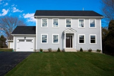 Inspiration for a large timeless blue two-story vinyl exterior home remodel in Providence