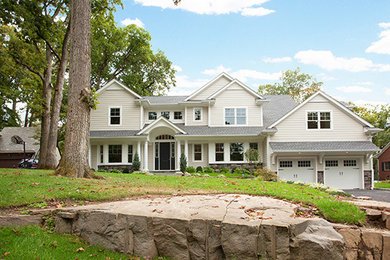 Large transitional beige two-story gable roof idea in New York