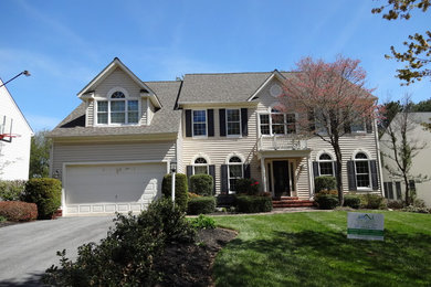 Large and beige classic two floor detached house in Baltimore with a pitched roof, vinyl cladding and a shingle roof.