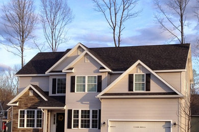 Example of a mid-sized classic white two-story vinyl exterior home design in Boston