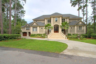 Example of a huge classic two-story stucco exterior home design in Atlanta with a hip roof