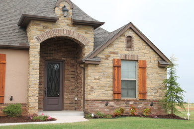 Example of a large transitional beige two-story mixed siding exterior home design in Oklahoma City