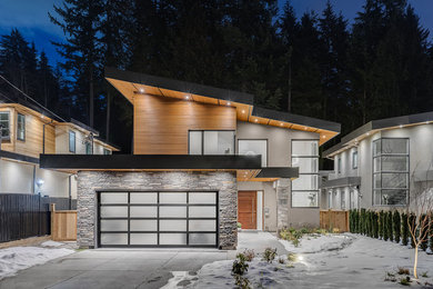 Trendy three-story house exterior photo in Vancouver with a metal roof