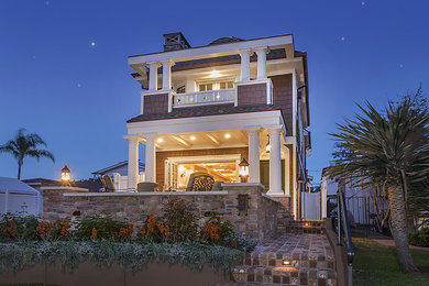 Mid-sized beach style brown two-story wood house exterior photo in San Diego with a hip roof and a shingle roof