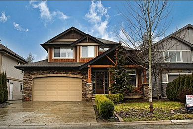 Photo of a large and brown rustic house exterior in Vancouver with three floors and mixed cladding.