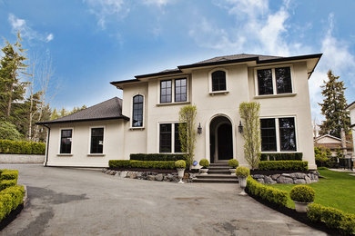 Inspiration for a white classic house exterior in Vancouver with stone cladding.