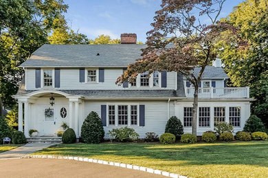 Mid-sized elegant white two-story vinyl exterior home photo in New York