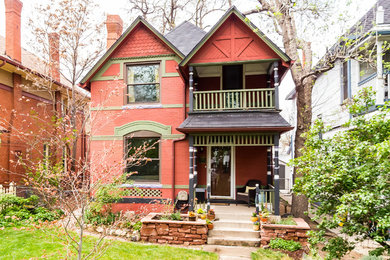 Mid-sized traditional red two-story brick exterior home idea in Denver