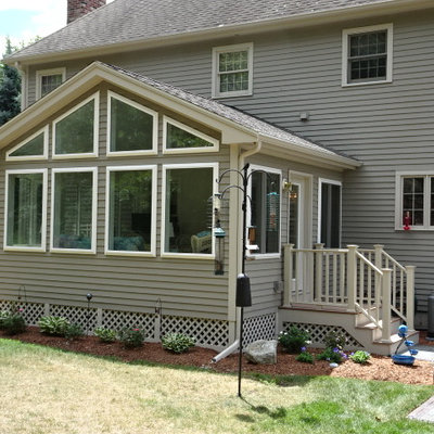 Huge traditional gray two-story concrete fiberboard exterior home idea in Boston with a clipped gable roof