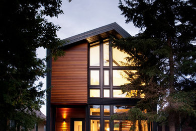 Modern gray two-story metal house exterior idea in Calgary with a metal roof