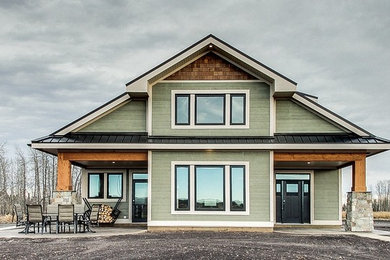 Mid-sized craftsman green two-story wood exterior home idea in Calgary