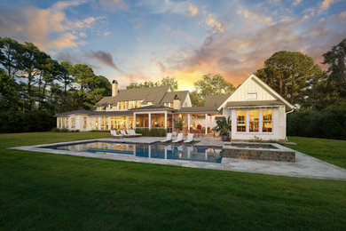 Inspiration for a large coastal white two-story wood exterior home remodel in Charleston with a mixed material roof