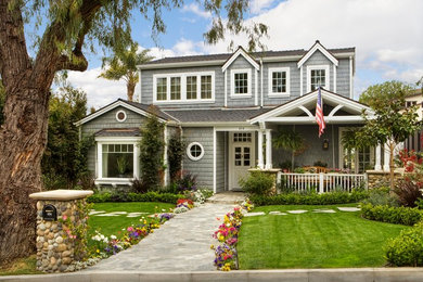 Mid-sized coastal gray two-story wood exterior home idea in Orange County with a shingle roof