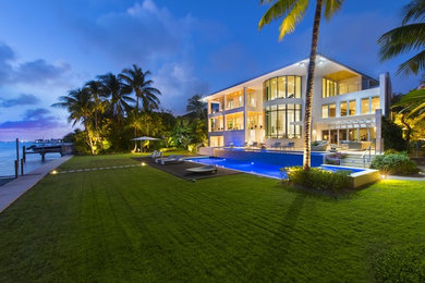 Example of a minimalist three-story exterior home design in Miami