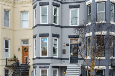 Large country gray three-story brick flat roof idea in DC Metro