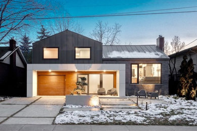 Example of a mid-sized minimalist black two-story metal exterior home design in Toronto with a metal roof