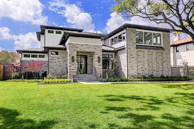 Large contemporary gray two-story mixed siding house exterior idea in Houston with a hip roof and a shingle roof