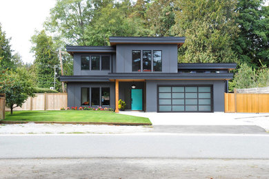 Example of a minimalist gray two-story house exterior design in Vancouver