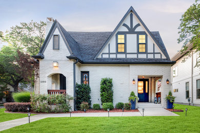 Large transitional white two-story brick exterior home photo in Dallas with a shingle roof