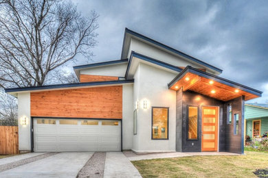 Mid-sized trendy gray two-story mixed siding house exterior photo in Austin with a shed roof