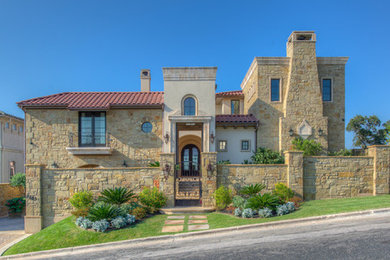 Example of a tuscan two-story exterior home design in Austin