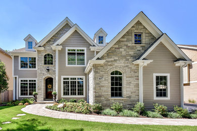Inspiration for a large craftsman beige two-story mixed siding exterior home remodel in Chicago