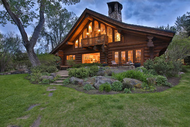 Huge mountain style brown one-story wood exterior home photo in Calgary