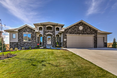 Large tuscan gray one-story mixed siding exterior home photo in Omaha