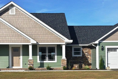Пример оригинального дизайна: одноэтажный, зеленый дом в стиле кантри с комбинированной облицовкой и двускатной крышей