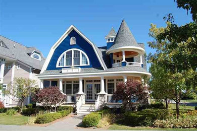 Inspiration for a large victorian blue three-story wood house exterior remodel in Other