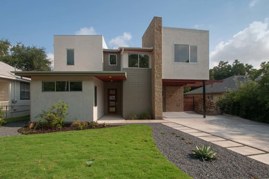 This is an example of a large and gey contemporary two floor house exterior in Austin with mixed cladding and a flat roof.