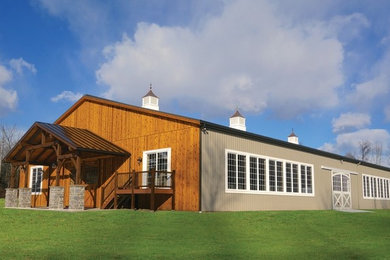 This is an example of an expansive and beige country bungalow house exterior in Other.
