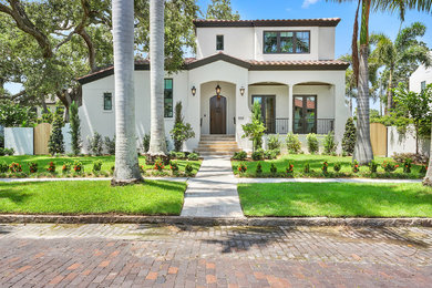 Example of a tuscan white two-story exterior home design in Tampa with a tile roof
