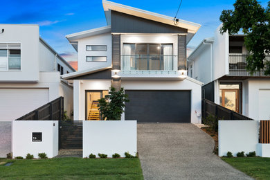 Example of a large trendy white two-story concrete fiberboard house exterior design in Brisbane with a butterfly roof and a metal roof
