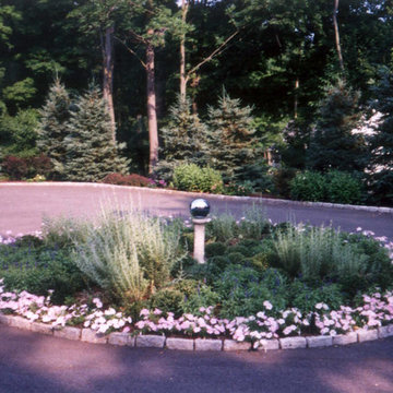 A boxwood parterre in a driveway circle adds winter interest