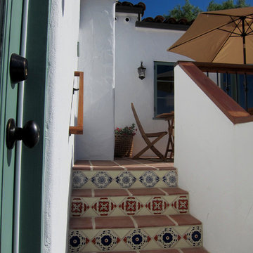 A charming Santa Barbara Spanish Patio Deck with spanish tile on stairs