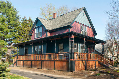 Ejemplo de fachada azul de estilo de casa de campo de tamaño medio de dos plantas con revestimiento de vinilo y tejado a dos aguas