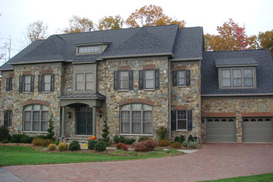 Large transitional beige two-story stone gable roof photo in DC Metro
