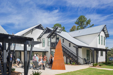 Large modern orange metal duplex exterior idea in Atlanta with a metal roof
