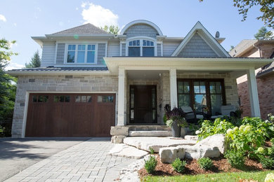 Mid-sized arts and crafts beige two-story mixed siding house exterior photo in Toronto with a hip roof and a shingle roof