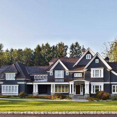 Large elegant black three-story gable roof photo in New York
