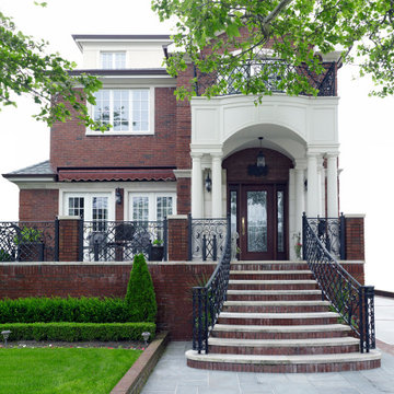 A small brick house with a grand portico