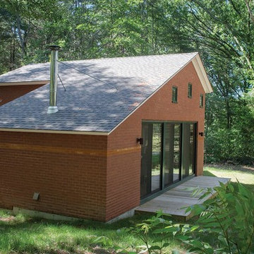 A tiny brick house, exterior side view