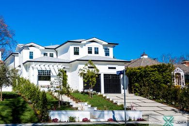 Mid-sized transitional white two-story vinyl house exterior photo in Los Angeles with a hip roof and a shingle roof