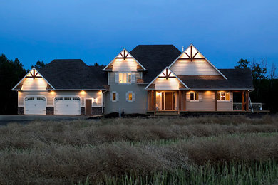 Example of a large minimalist beige two-story mixed siding exterior home design in Calgary