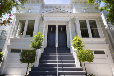 This is an example of a large and white modern terraced house in San Francisco with three floors and a flat roof.