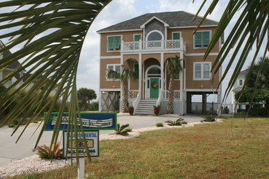 Large beach style brown three-story concrete fiberboard exterior home photo in Raleigh