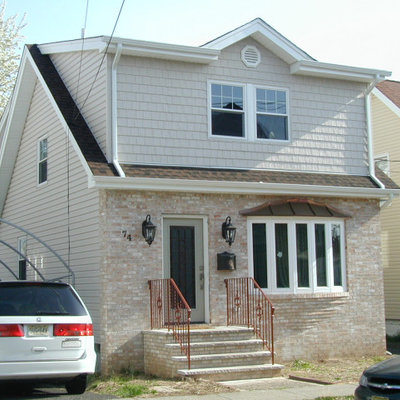 Mid-sized elegant beige two-story mixed siding exterior home photo in New York with a shingle roof